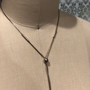 Silver necklace, best for plunging necklines.